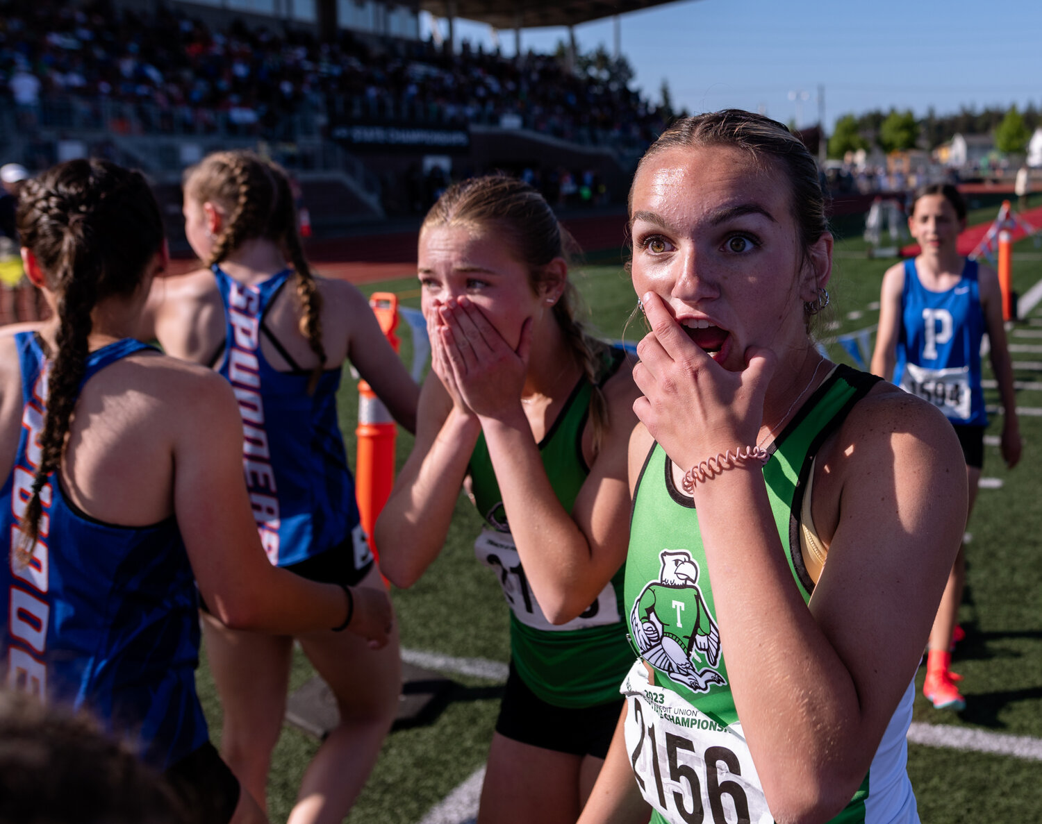 Tumwater’s Cassidy Hedin and Reese Heryford await word from Ava Jones on whether their victory in the 4x400 was enough to win the team title at the WIAA 2A/3A/4A State Track and Field Championships on Saturday, May 27, 2023, at Mount Tahoma High School in Tacoma. (Joshua Hart/For The Chronicle)
